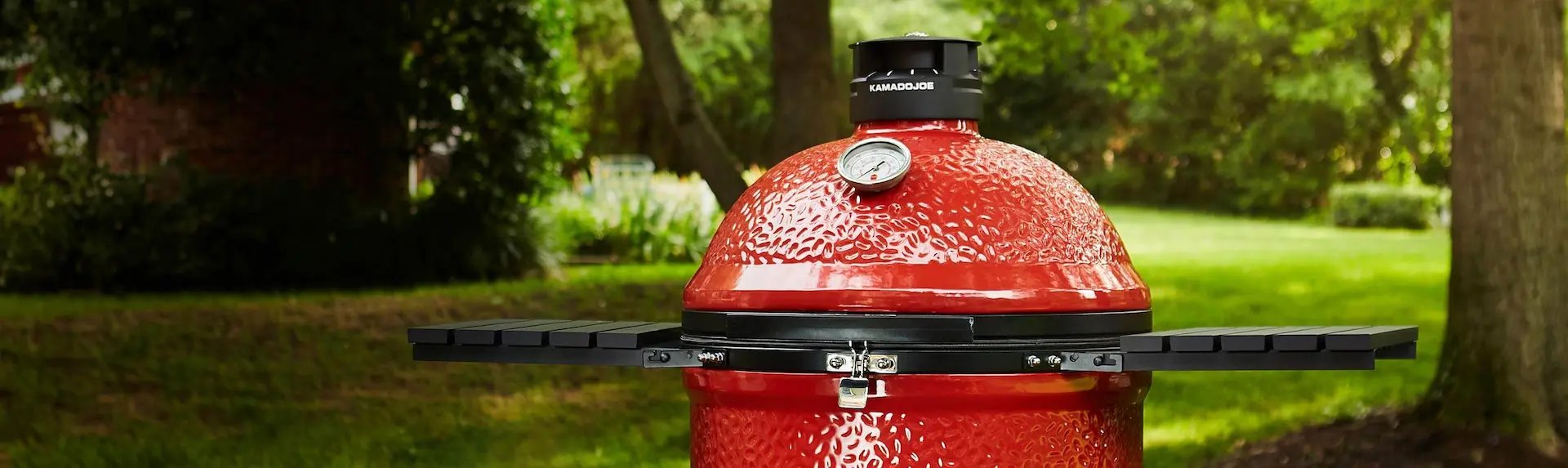 a red Ceramic Smokers & Grills in an outdoor area